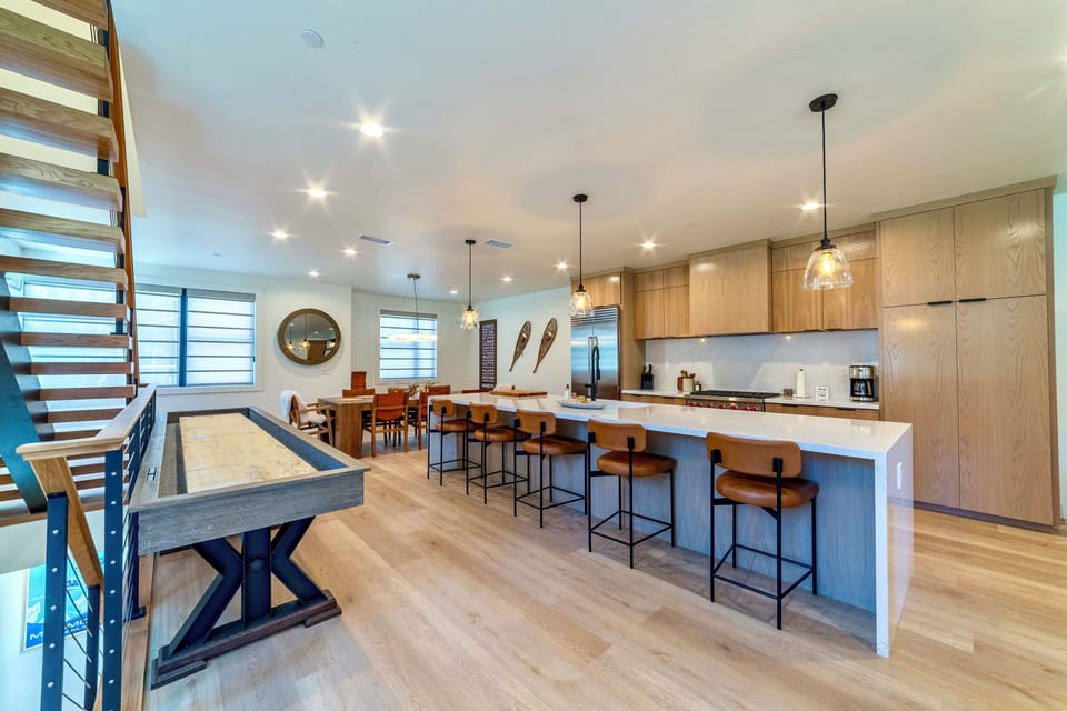 Open living area with kitchen, dining room, and shuffleboard table!