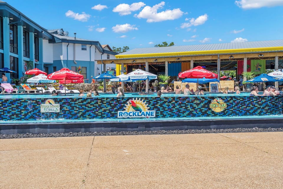 The ultimate poolside scene! Float, sip, and mingle at Rock Lane's lively infinity pool — with the Rock Island Tiki Bar and Grill just steps away for the perfect lakeside party vibe.
