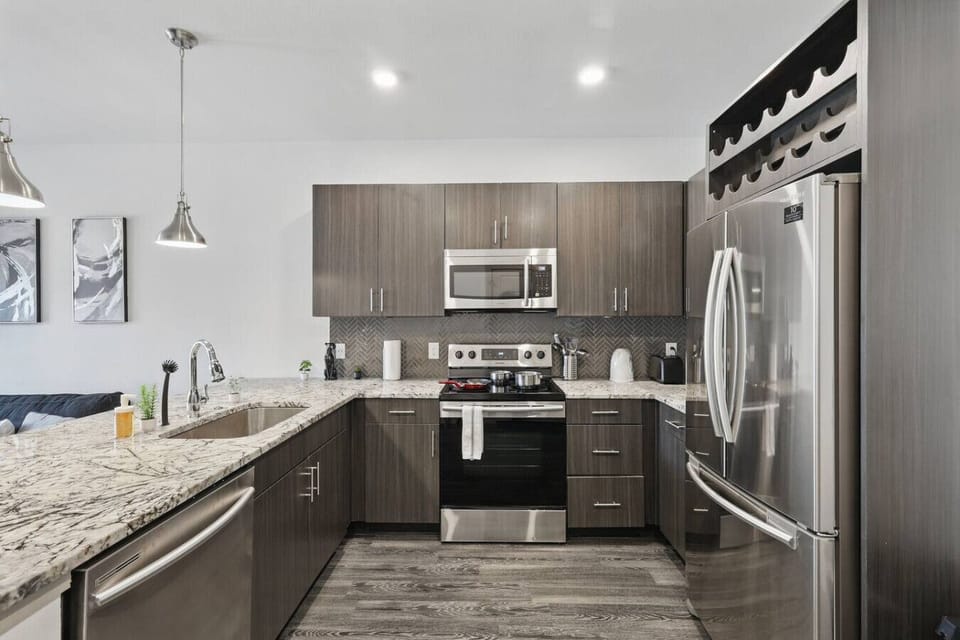 - Contemporary kitchen with granite counters and storage - Stainless refrigerator, microwave and electric stove - Open layout apartment ideal for long stays