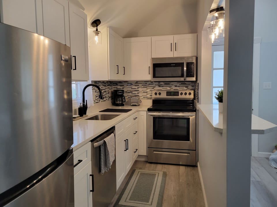 This full kitchen is also fully remodeled with new stainless steel appliances.
