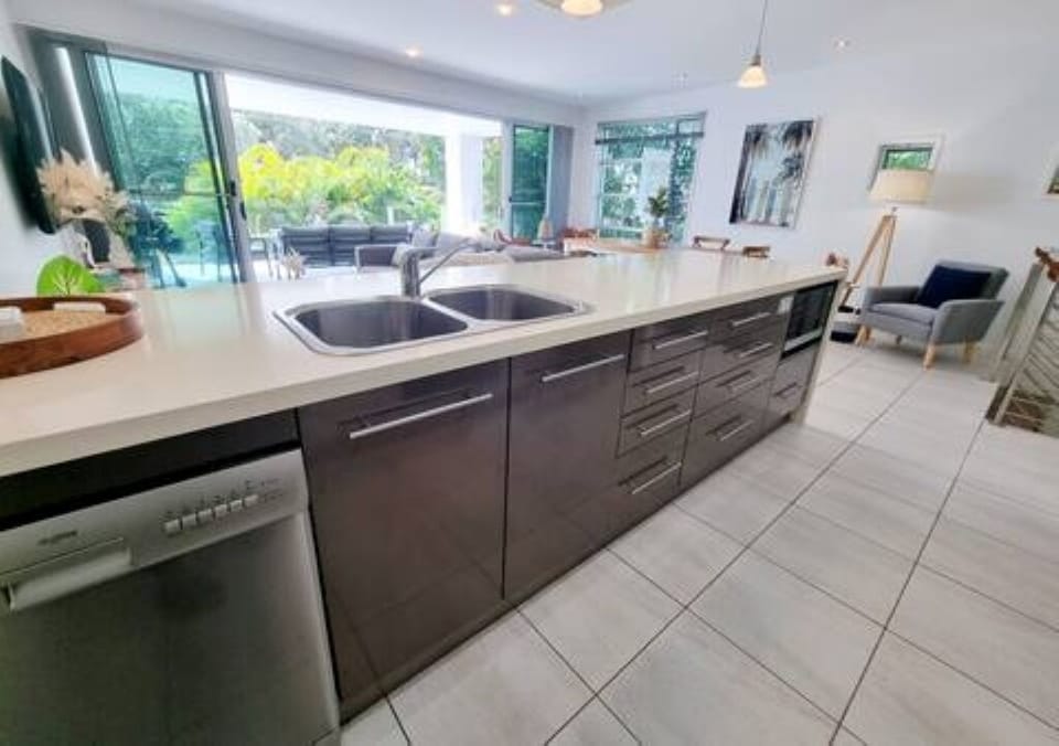 Fully stocked kitchen with dishwasher, microwave, double fridge, cooktop & oven