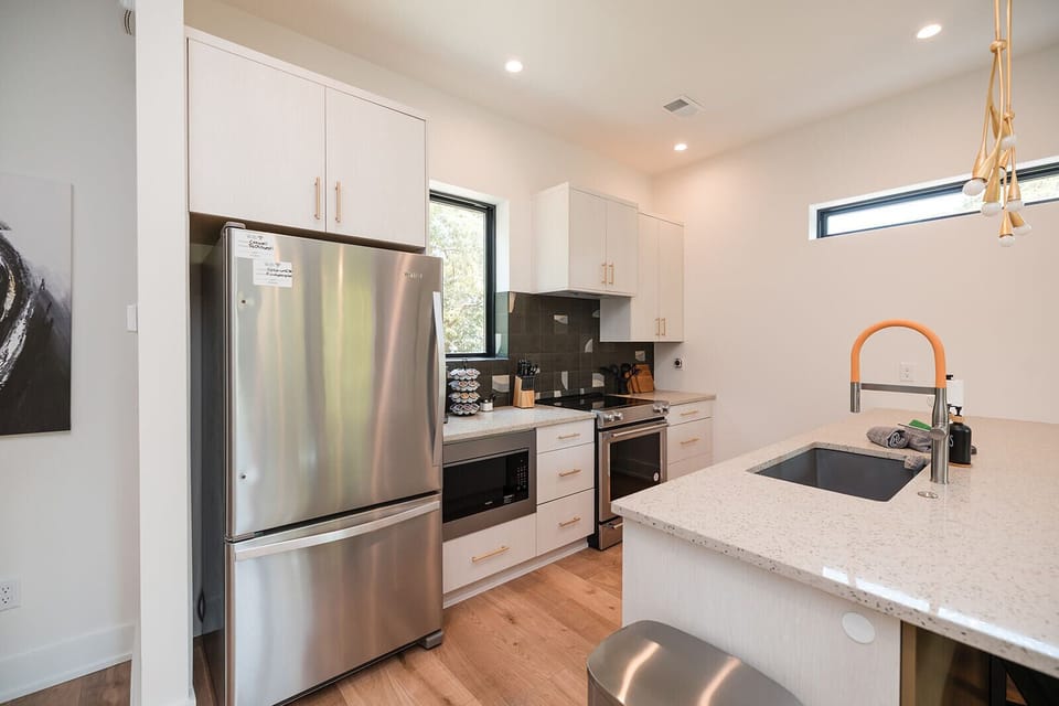 The fully stocked kitchen includes cookware, essentials, and everything needed for preparing meals and hosting guests in style.