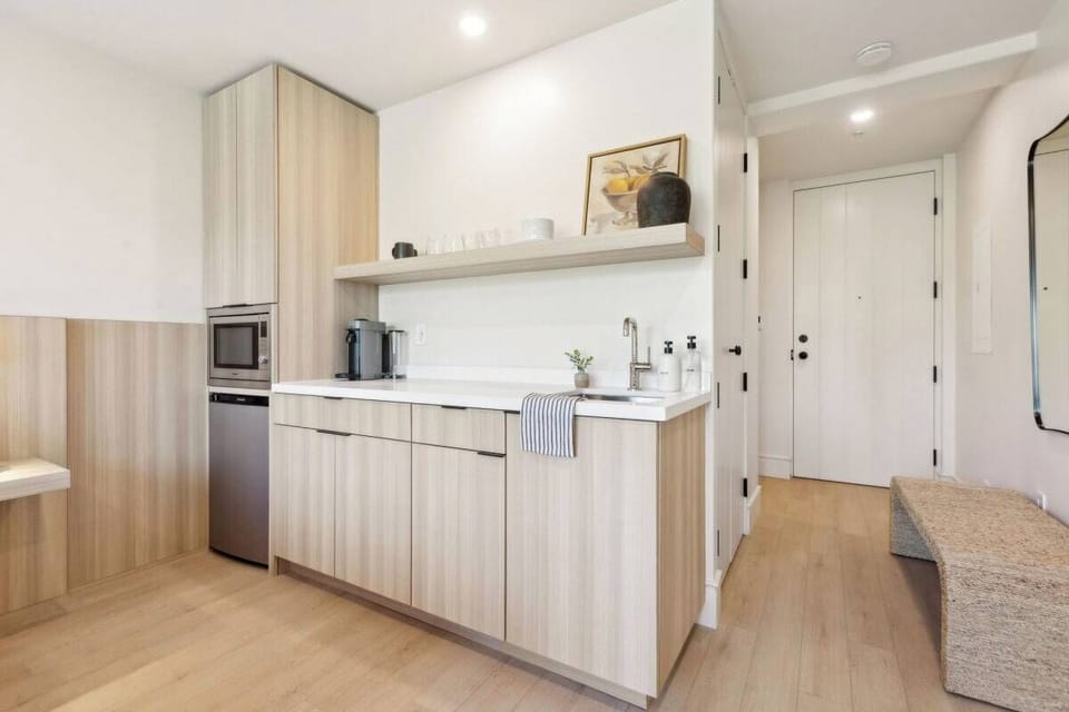 Nespresso, mini-fridge,  microwave/air-fryer, plates/utensils. No stove.
