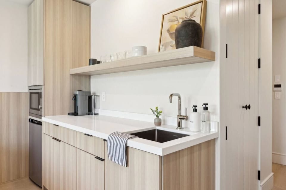 Nespresso, mini-fridge,  microwave/air-fryer, plates/utensils. No stove.
