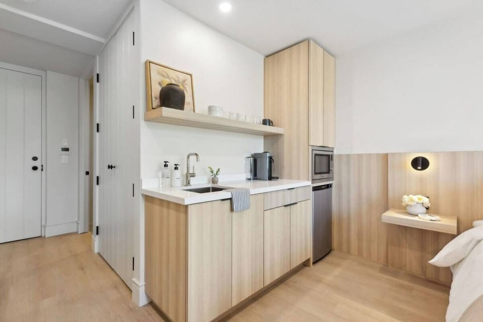 Nespresso, mini-fridge,  microwave/air-fryer, plates/utensils. No stove.