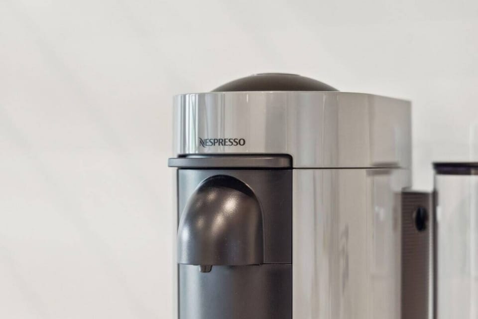 Nespresso, mini-fridge,  microwave/air-fryer, plates/utensils. No stove.