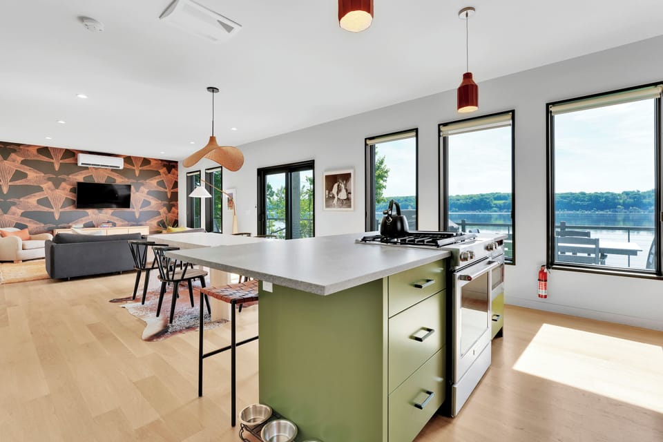 Open concept with full river views, dining room connected to living room and kitchen
