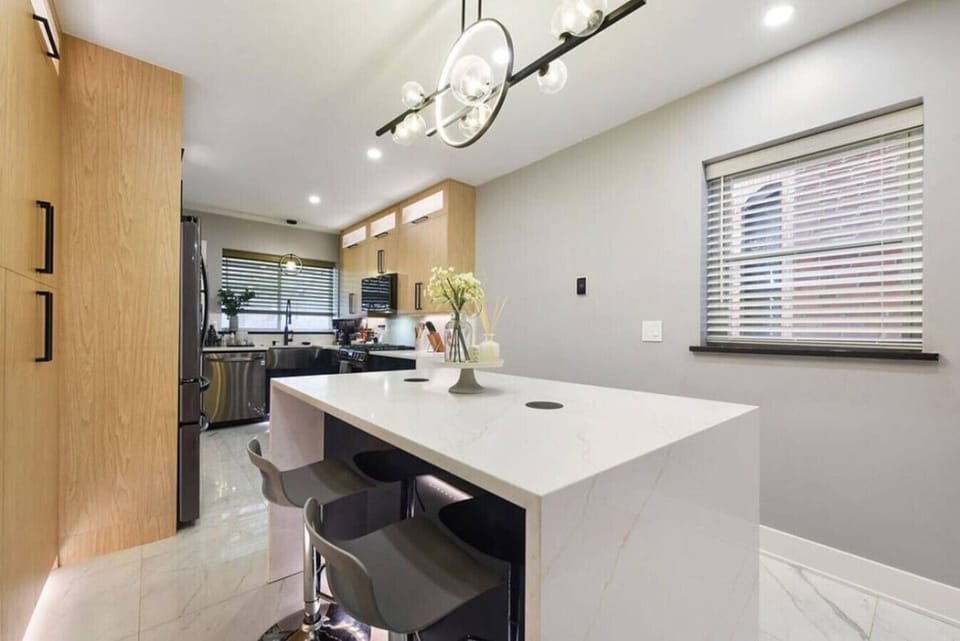 Modern kitchen island with bar stools, ideal for casual meals or socializing.
