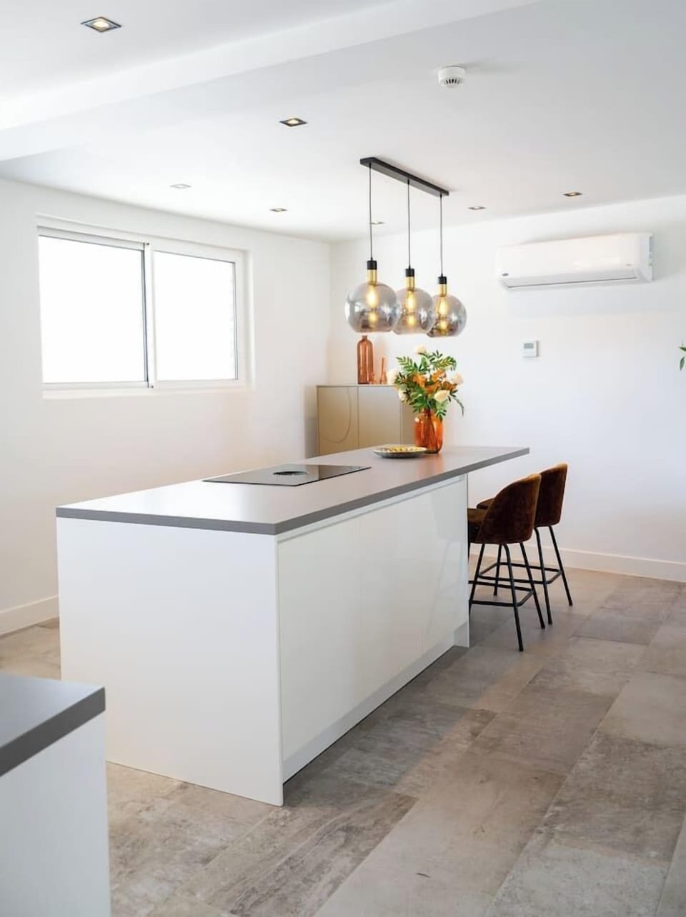 Clean, modern kitchen with island seating—great for quick meals, coffee, or just hanging out.