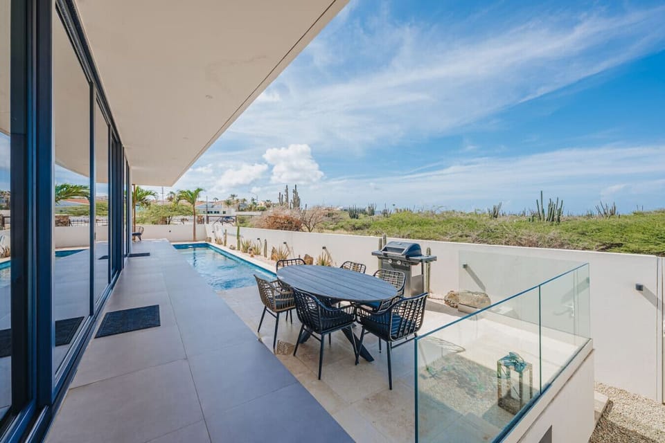 Enjoy outdoor dining by the pool with a BBQ grill, comfortable seating, and plenty of space to gather with family and friends.