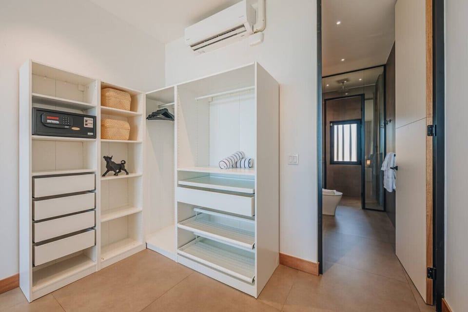 The walk-in closet offers plenty of space for luggage, clothing, and personal items, helping keep the bedroom clutter-free.