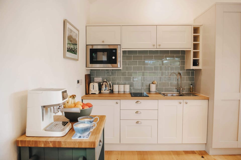 Kitchenette & Dining Area, equipped with all cooking equipment, wins & fizz glasses, a coffee machine, refrigerator, kettle and toaster - salt & pepper, 4 person dining table and beautiful ceramics.