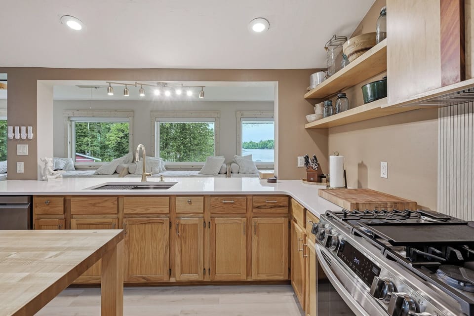 The kitchen is perfectly situated in the center of the upper level, allowing you to prepare meals while still spending time with family and friends in the dining room or on the daybeds. Bonus: It also features panoramic lake views!