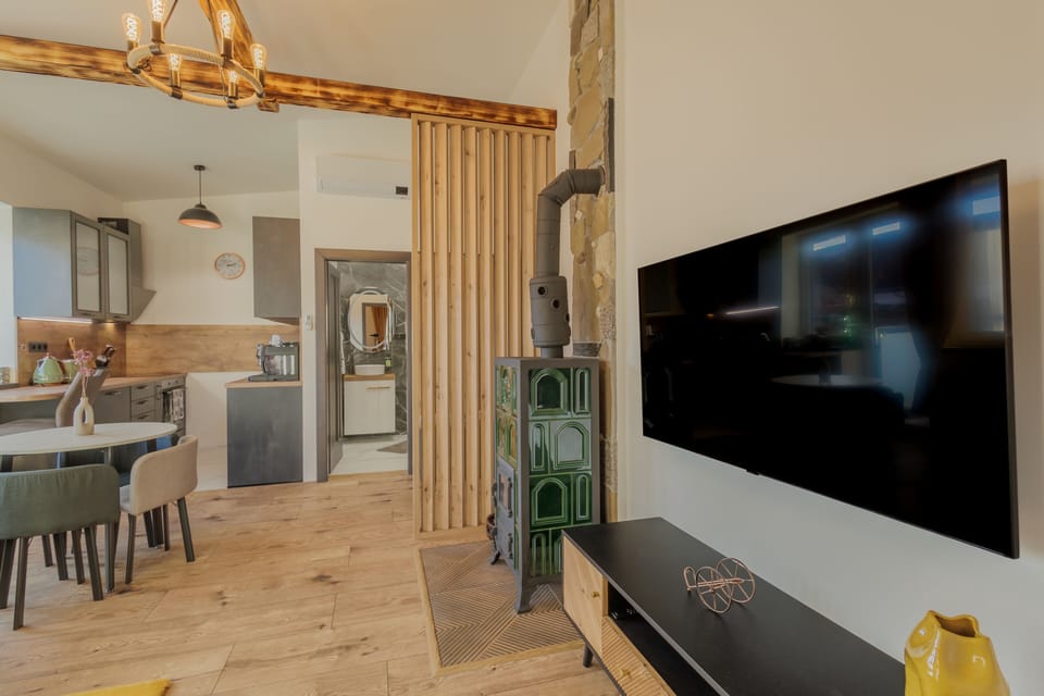 Deluxe Apartment, Balcony, Garden View | Living area | Flat-screen TV, heated floors