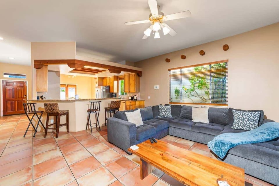 Comfy lounge with a plush sofa and an open kitchen