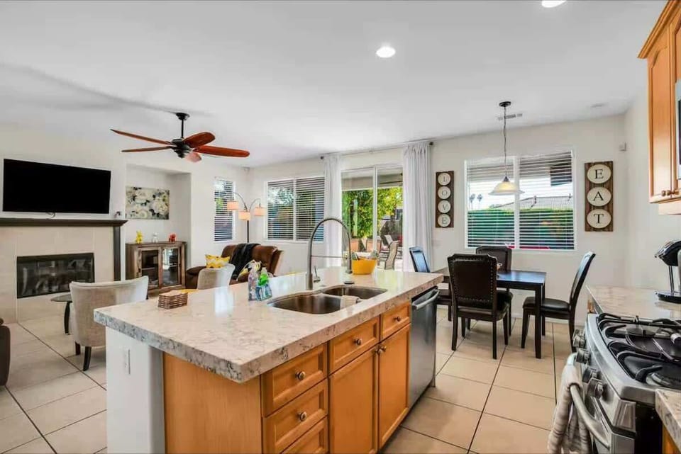 Open-concept kitchen and living area, perfect for cooking, relaxing, and entertaining — with easy access to the patio for seamless indoor-outdoor living.