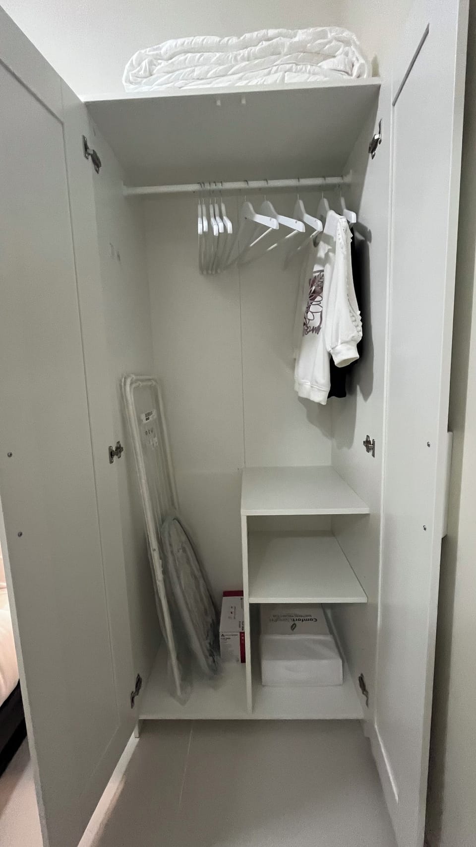 Wardrobe cabinet with hangers, iron and ironing board, clothes drying hamper
