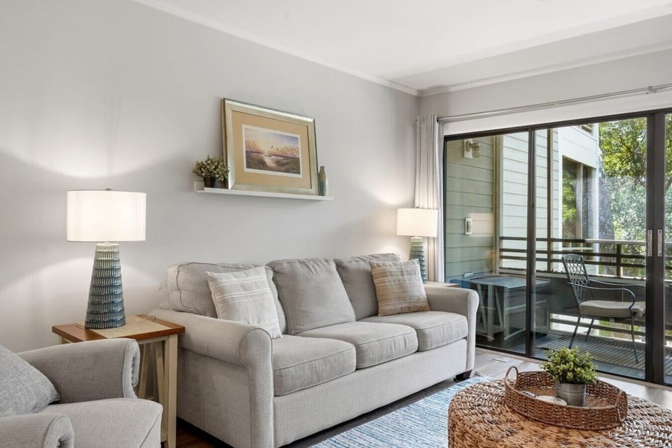 Plush recliner and full-sized couch set the scene in this cozy living room, a great way to start the day.