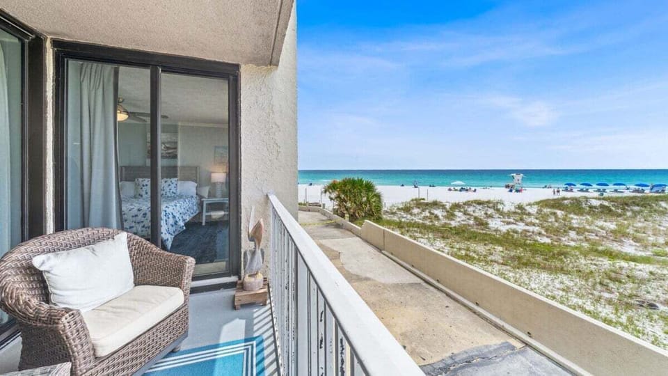 Relax on your private balcony with stunning views of sugar-white sand and emerald waters, just steps from the beach.