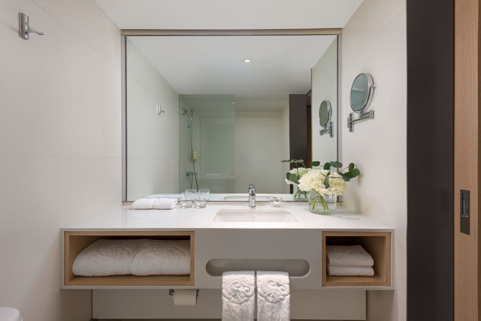 Shower, designer toiletries, hair dryer, bathrobes