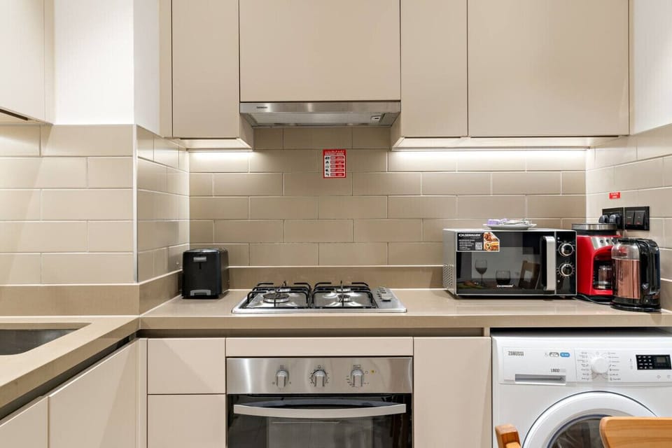 Kitchen: Culinary adventures await in this sleek, well-equipped kitchen with modern appliances!
