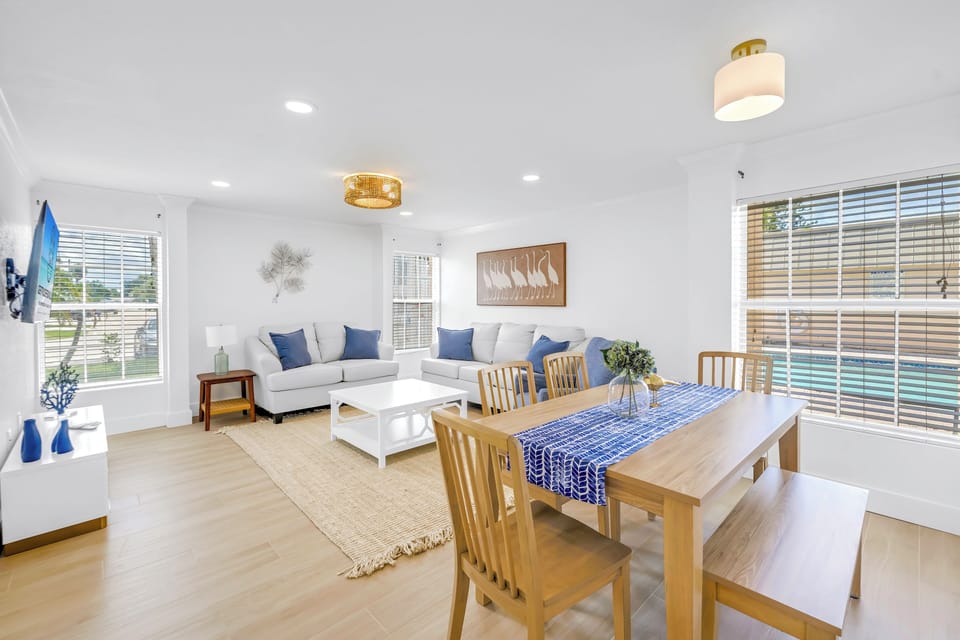 Bright 2-bedroom rental with open living and dining space, modern decor, and natural light throughout. Walk to Siesta Key Beach and Village.