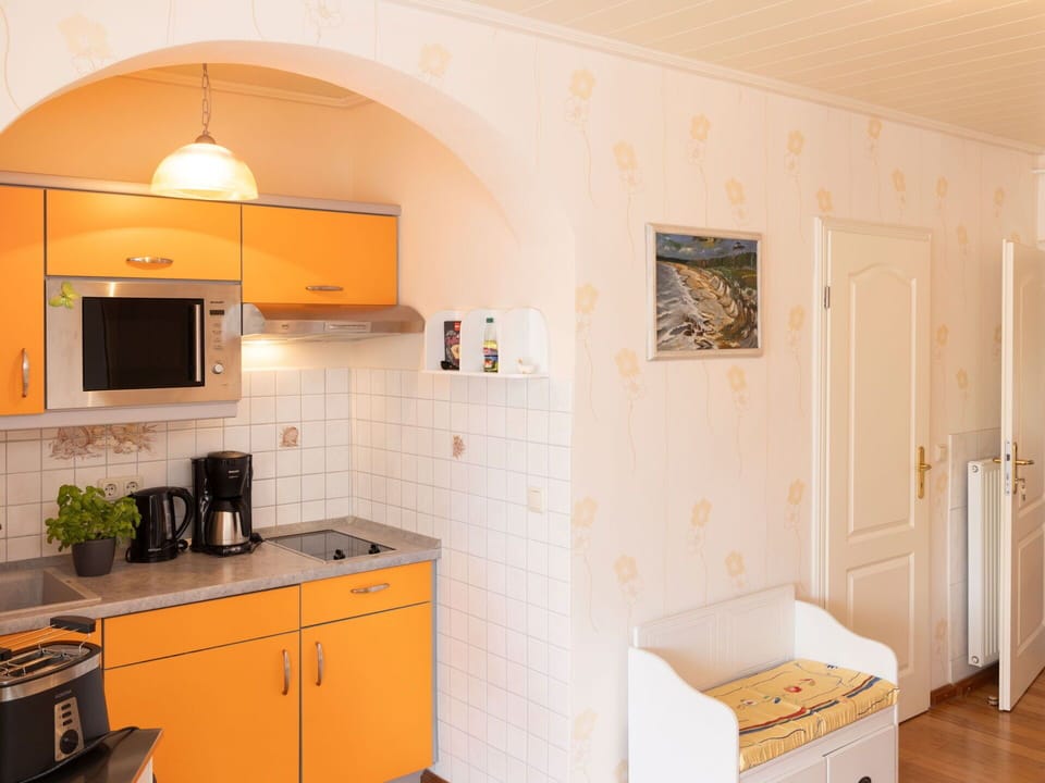 Furniture, Interior Design, Flooring, Wood, Floor, Room, Ceiling, Lighting, Orange, Countertop