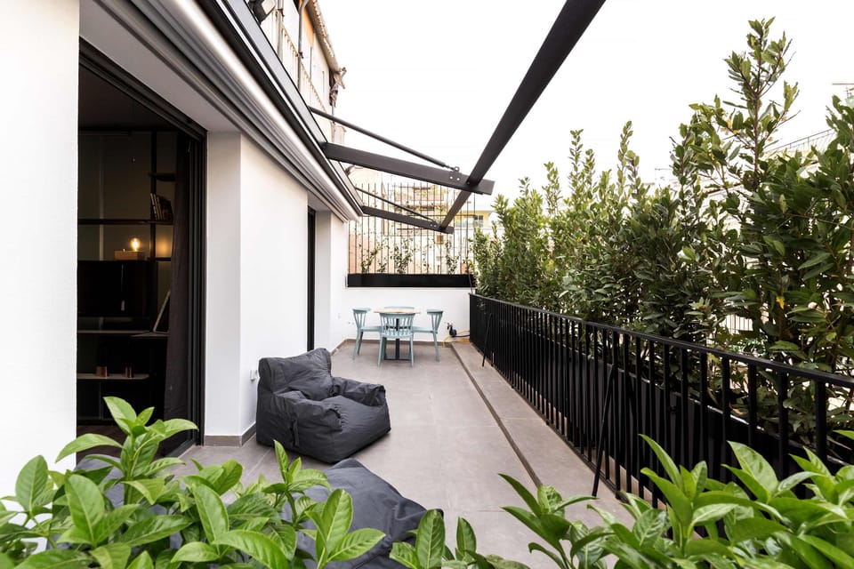 Expansive private balcony offers peaceful greenery views and relaxing outdoor moments in city center.
