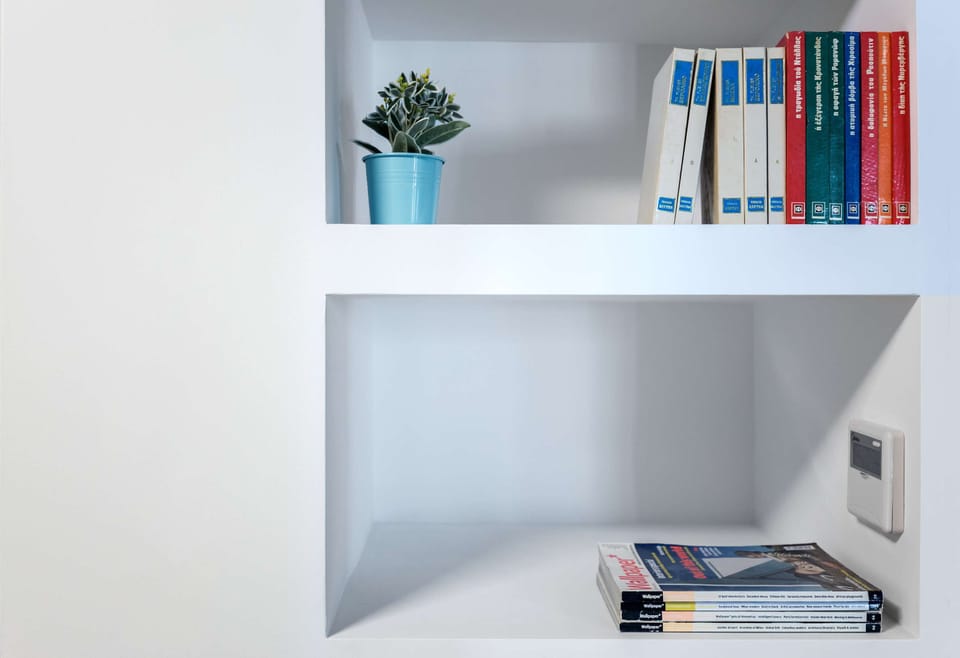 Neatly styled shelving keeps essentials organized while enhancing the apartment’s polished contemporary aesthetic.