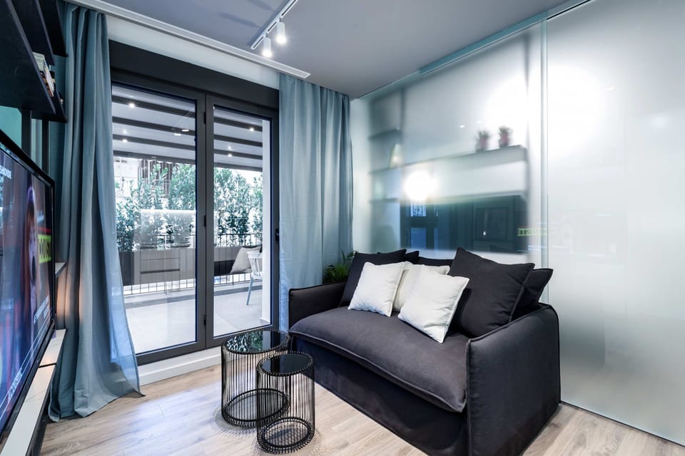 Cozy sofa corner creates relaxing retreat with stylish lighting and calming modern ambiance.
