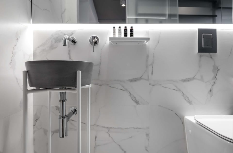 Elegant marble bathroom with premium fixtures delivers a refreshing, spa-like shower experience every day.