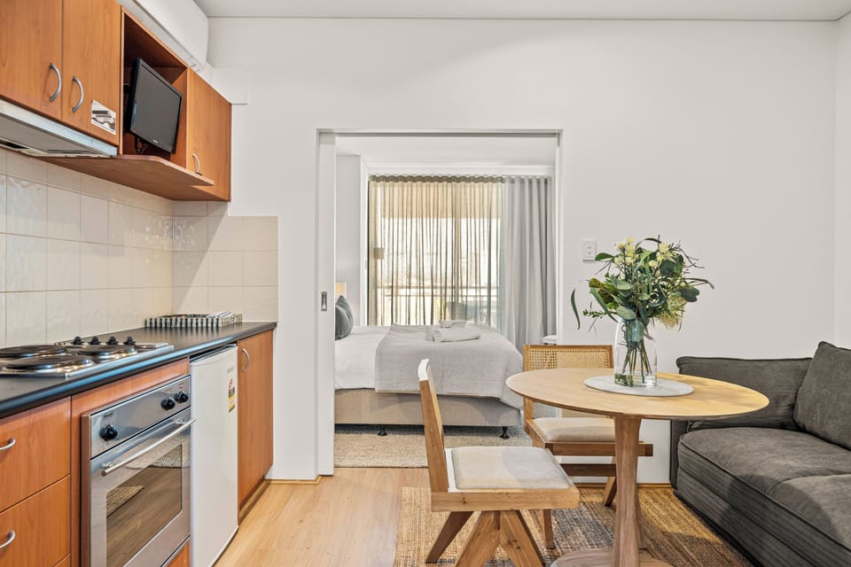 Compact yet complete: enjoy dining, a kitchenette, and a comfortable bedroom all in one convenient layout. 