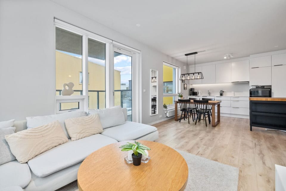 Enjoy the seamless flow between kitchen, dining, and living areas in this well-lit Reykjavik apartment, designed for modern comfort and relaxation