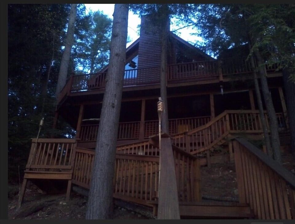 Exterior view of cabin, looking up from lake edge