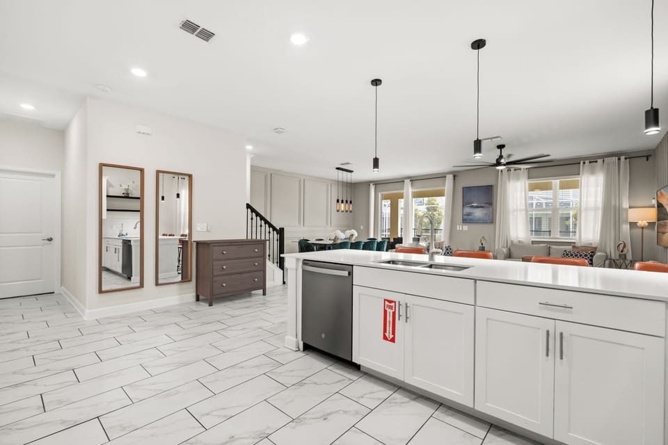 Kitchen Area With Dishwasher, Dual Sink & Living Room/Dining In Background