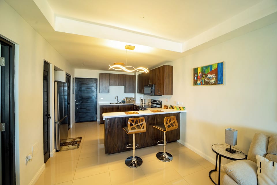 Kitchen with 2 Bar Stools, Refrigerator, Stove with Oven and Microwave
