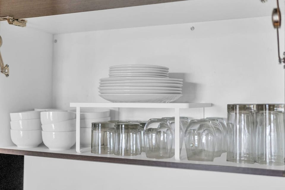 Kitchen cabinets stocked with cooking wares, glassware and silverwares, ideal for mixing up your favorite meals and drinks during your stay.