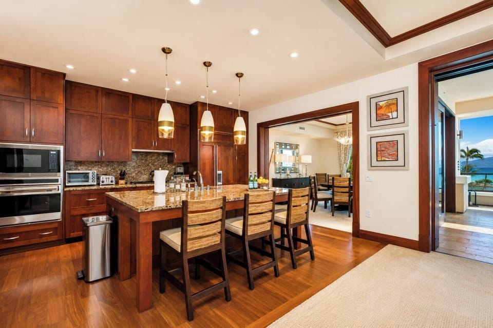 Fully equipped gourmet kitchen opens to the dining area for easy entertaining