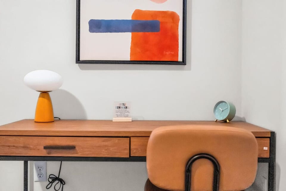 This cozy workspace with warm lighting, and a creative wall display, perfect for productivity.