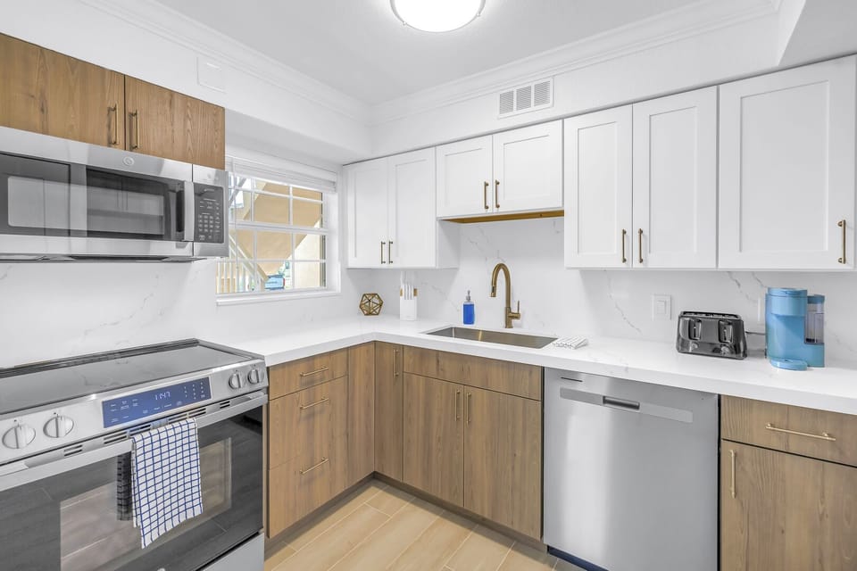 New kitchen with plenty of counter space and full-sized fridge.