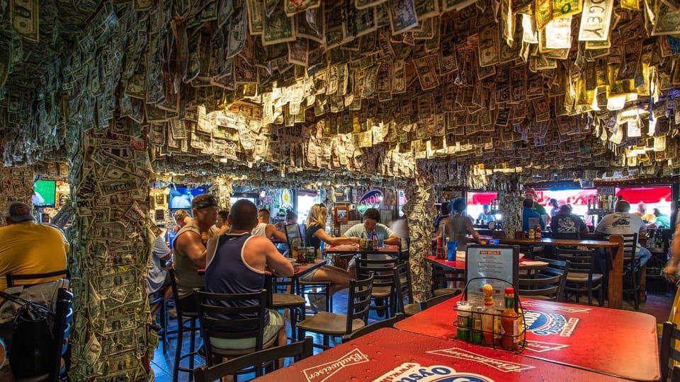 A fun, laid-back seafood spot known for live music, oysters, and dollar-covered walls.