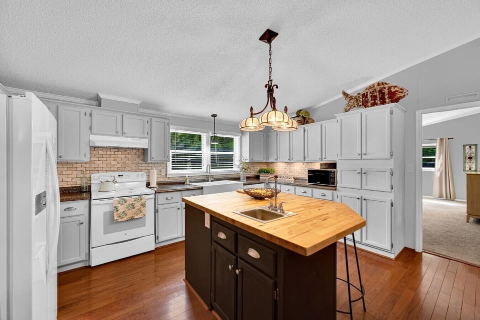 Kitchen | Kitchen Island with Butcher Block & Sink | White Cabinetry & Hardwood Floors