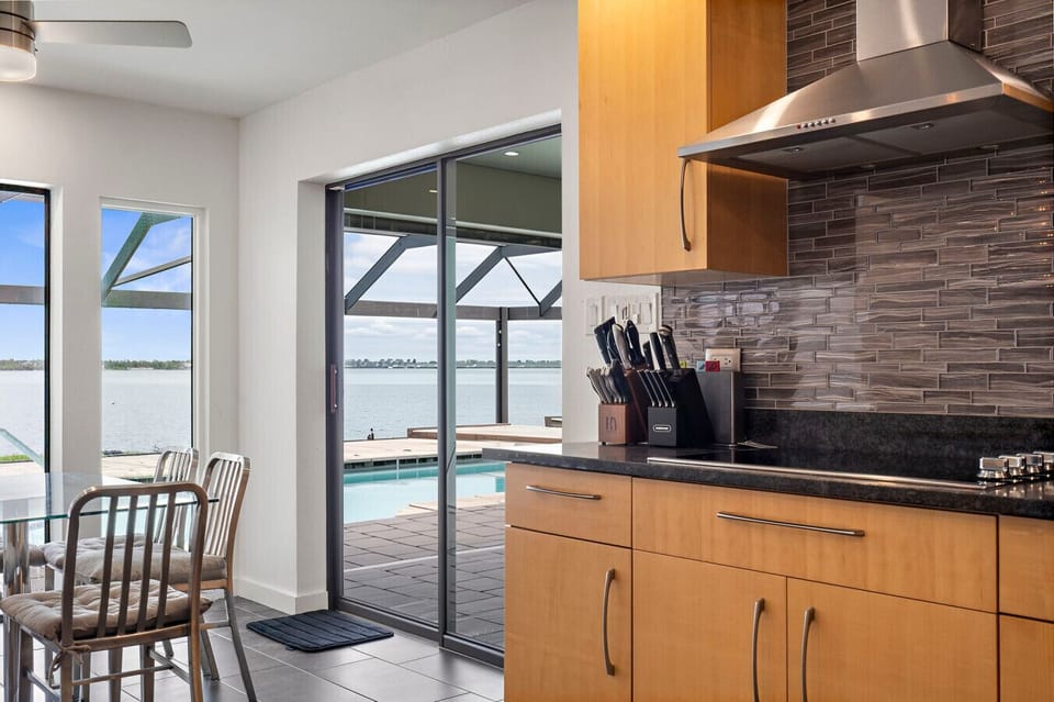Kitchen with Patio Access | Poolside Views & Sleek Finishes