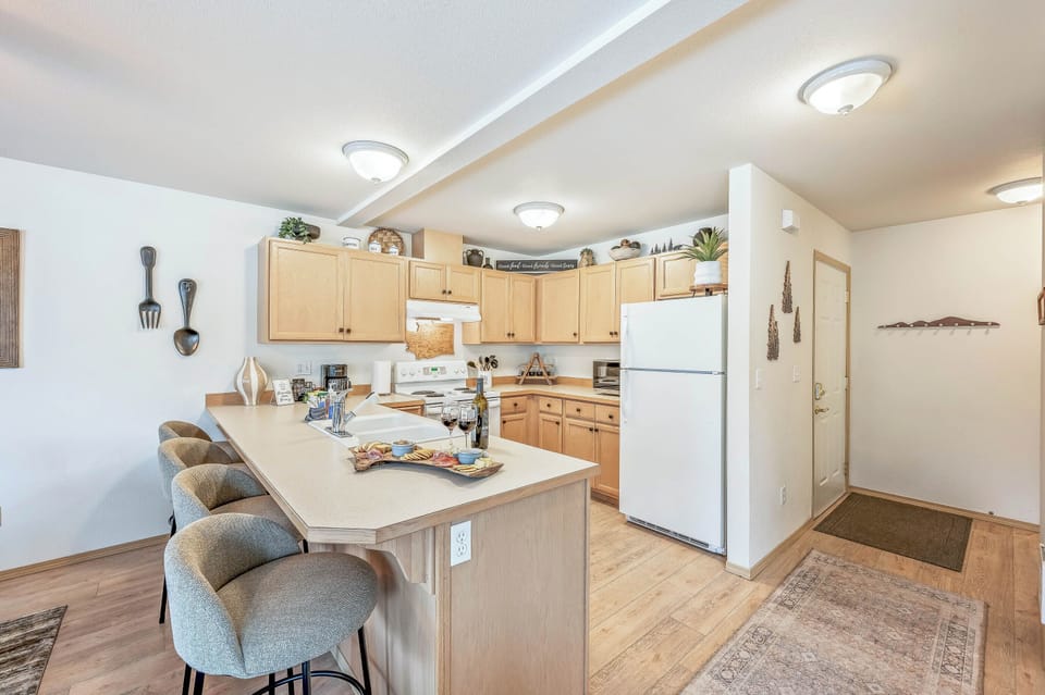 Fully stocked kitchen with peninsula seating for four