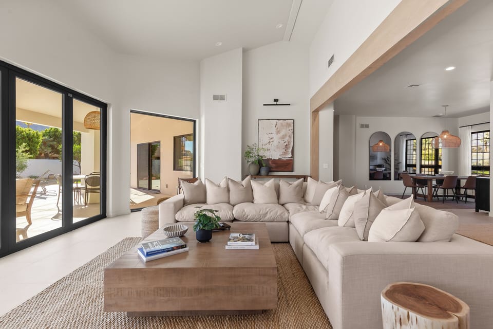 Large living area with fireplace and view of the pool / patio spaces.