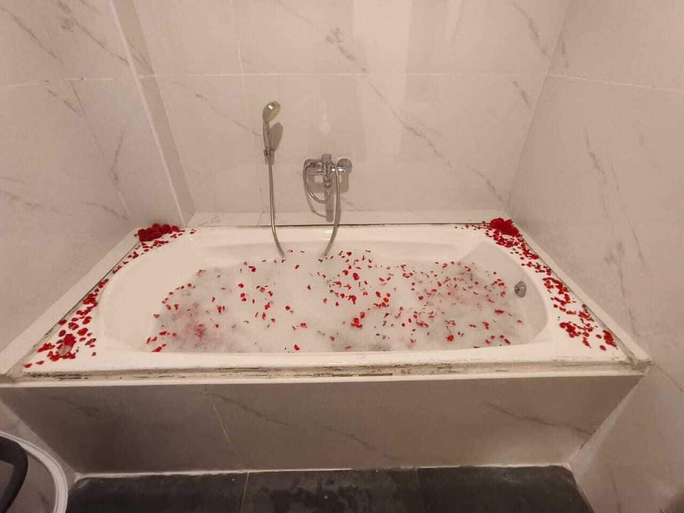 Separate tub and shower, slippers, towels, soap