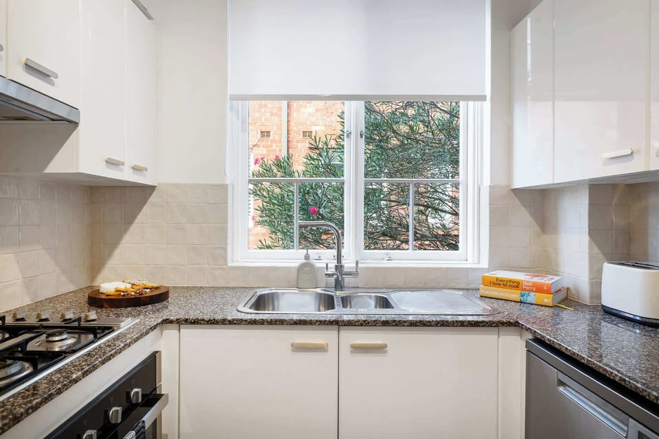 Spacious kitchen with gas hob, oven, dishwasher and large fridge