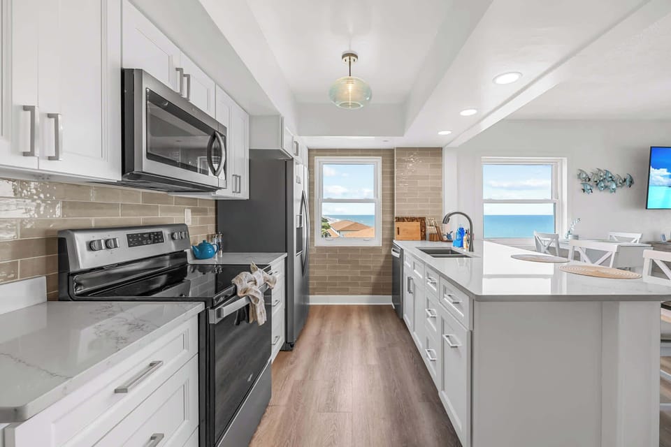 Modern kitchen with ocean views through two windows