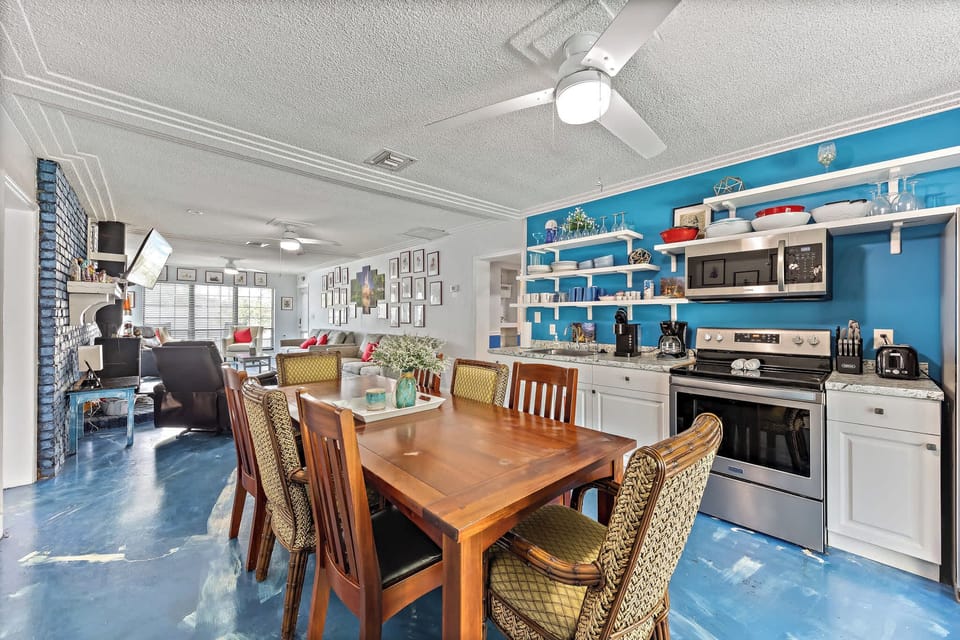 Bright blue dining area and kitchen open plan