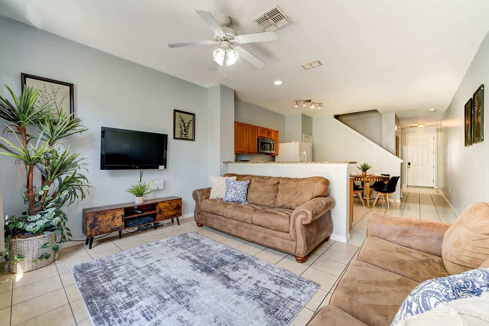 Open living area with comfortable seating and a wall-mounted television
